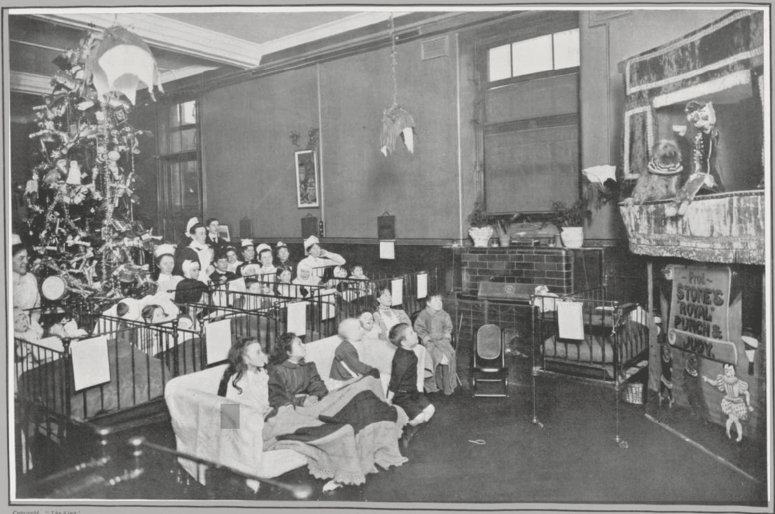 Children watching a Punch and Judy performance in a hospital ward